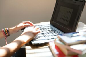 Girl typing on a laptop while remote learning at home