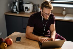 Young man working remotely and heaving a meeting